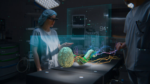 Medical professionals in AR headsets work in operating room using holographic display. 3D graphics of virtual human skeleton and organs. Technology of AI-assisted surgery. Healthcare innovation.