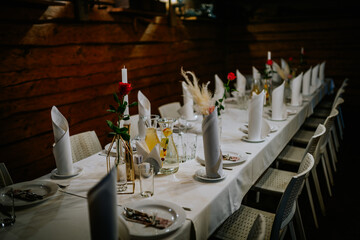 A white table is laid in the log building