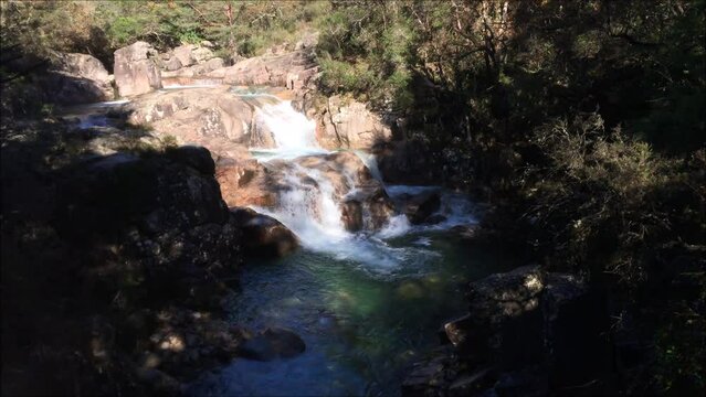 Cascata na serra do Ger&ecirc;s em Portugal, &aacute;gua de um rio de montanha a correr por entre as pedras em ambiente de outono