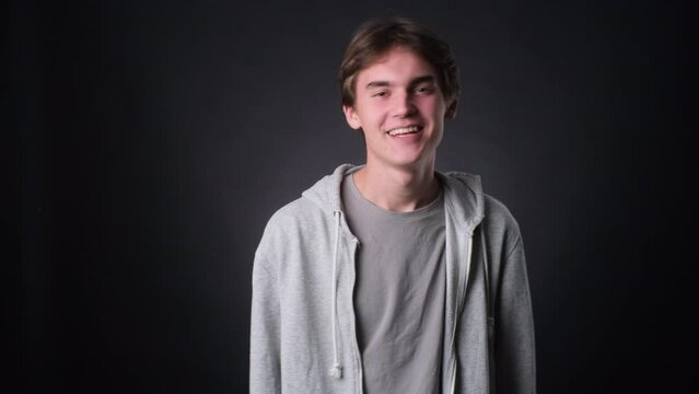 Positive Caucasian Man Laughing Against black Background