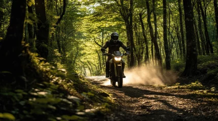 Tragetasche Motorcyclist in sun-drenched forest trail warm colors relaxed posture © javier
