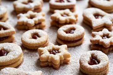 Homemade Linzer Christmas cookies filled with red jam and dusted with sugar