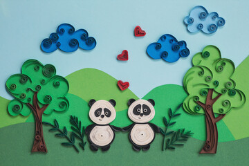 Cute couple panda in love with hearts. Two funny pandas quilling character in field, near trees in summer day with clouds. Happy cute panda fall in love. Hand made of paper quilling technique.