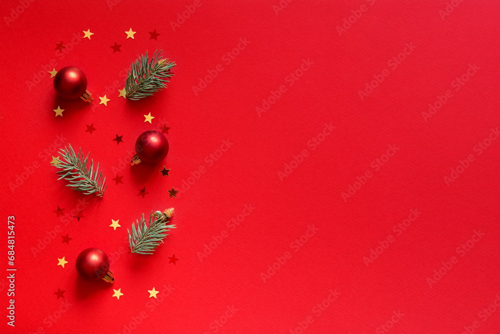 Sticker Red Christmas background. Top view photo of red christmas tree,  red christmas balls, gold star ornaments and pine branches with empty space. Christmas Eve concept.