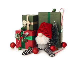 Christmas gnome with gift boxes, decorative fir, candy canes and balls isolated on white background