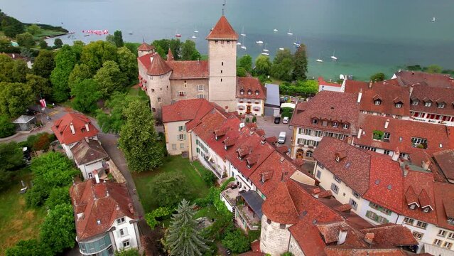 Switzerland Murten 4K Aerial Drone Video of Scenic Medieval Town Morat on Lake with Historic Castle Tower Fortification Walls and Lakefront View Canton Fribourg Travel