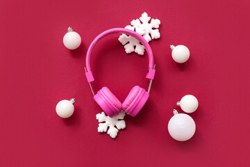 Headphones with Christmas decor on red background