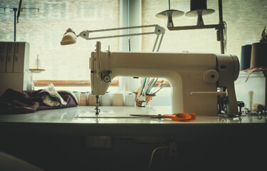Seamstress's workplace. Sewing machine and various accessories.