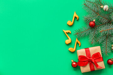 Music notes with gift box and Christmas decor on green background