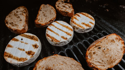 Grilled camembert, on old dark grille