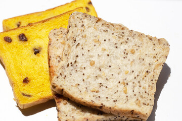 Whole grain bread slices on blue background.