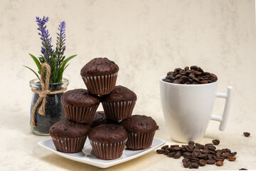 Chocolate muffins stacked on a white plate, Muffins on a plate and marble background,lavender decoration