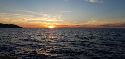 Fototapeta na wymiar Calm sea at sunset with beautiful sky and peaceful horizon