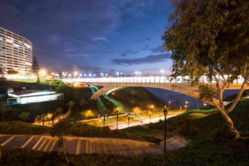 PERU Panoramic view of the Villena Rey Bridge of the Miraflores district with luxurious apartments and Pacific Ocean at night © Luis