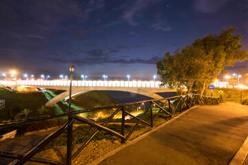 PERU Panoramic view of the Villena Rey Bridge of the Miraflores district with luxurious apartments and Pacific Ocean at night © Luis