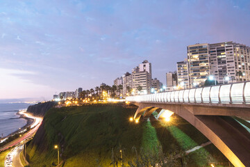 PERU Panoramic view of the Villena Rey Bridge of the Miraflores district with luxurious apartments and Pacific Ocean at night © Luis