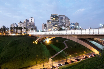 PERU Panoramic view of the Villena Rey Bridge of the Miraflores district with luxurious apartments and Pacific Ocean at night © Luis