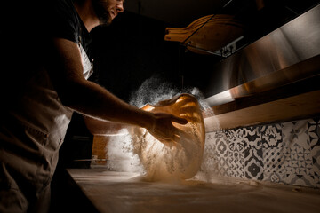 Pizza dough tossing technique by the chef - obrazy, fototapety, plakaty