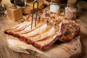 Smoked pork bone on wooden board.