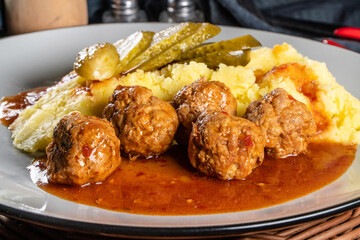 Meatballs pork and mashed potatoes topped with paprika gravy.