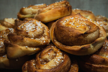 A pile of delicious Swedish cinnamon buns. Freshly baked homemade Swedish fika. Close up photo.