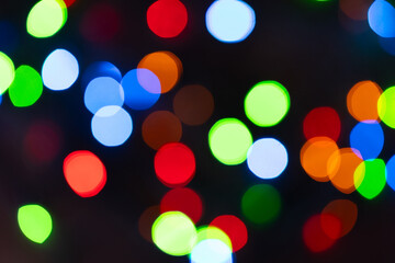 Colourful festive bokeh lights on background. Abstract multicolored light. Christmas or New Year...