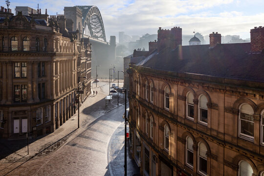 Newcastle Upon Tyne's famous Tyne Bridge and quayside at sunrise