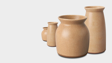 Closeup of earthenware ceramic jars, isolated on grey copy-space background.