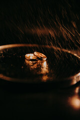 wedding rings in smoke on a black background