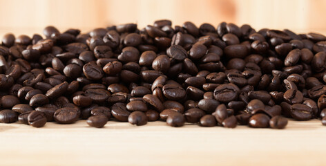 Fototapeta premium Image of fresh coffee beans on natural wooden background, nobody