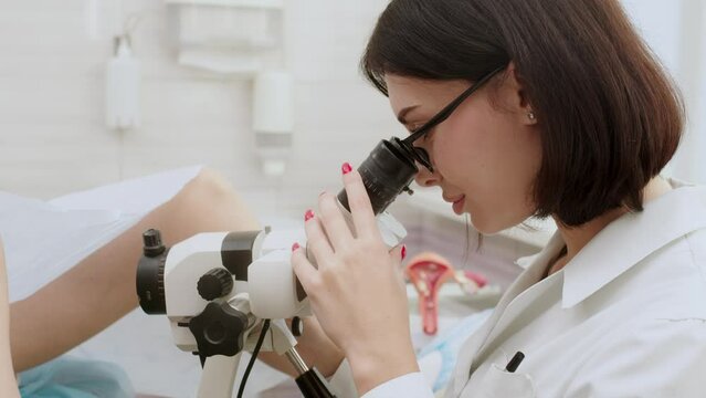 Gynecologist examining patient on chair with gynecological equipment. Friendly cheerful nurse giving medical consultation to young woman. Health concept. Telemedicine and human Uterus recovery concept