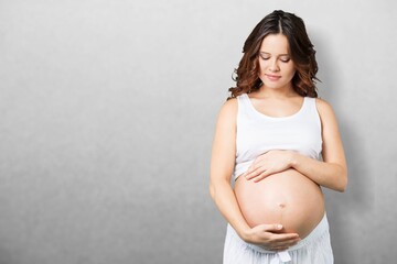 Happy pregnant woman standing at home, waiting for baby