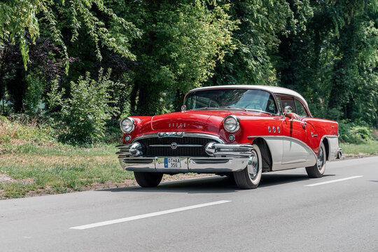 1955 Buick Special Riviera Hardtop Coupe in Cherokee Red and White  colors is driving in Palic, Serbia, 02.07.2023