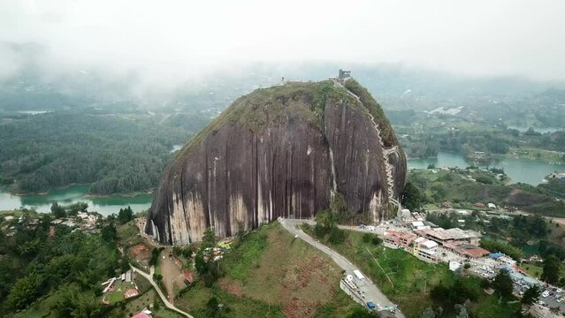 Aerial drone footage of El Penon de Guatape near Medellin in Antioquia, Colombia. Large and unique alone rock with stairs to the top, touristic place. Big stone in Colombia. High quality 4k footage.