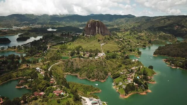 Aerial drone footage of El Penon de Guatape near Medellin in Antioquia, Colombia. Large and unique alone rock with stairs to the top, touristic place. Big stone in Colombia. High quality 4k footage.