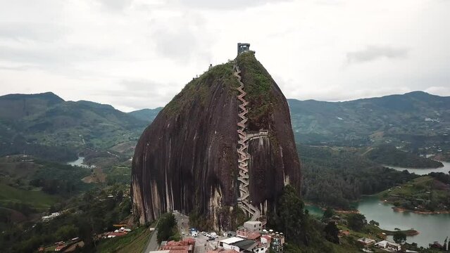 Aerial drone footage of El Penon de Guatape near Medellin in Antioquia, Colombia. Large and unique alone rock with stairs to the top, touristic place. Big stone in Colombia. High quality 4k footage.