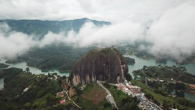 Aerial drone footage of El Penon de Guatape near Medellin in Antioquia, Colombia. Large and unique alone rock with stairs to the top, touristic place. Big stone in Colombia. High quality 4k footage.