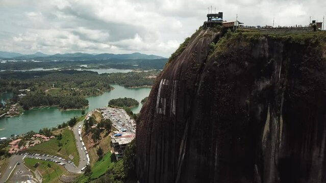 Aerial drone footage of El Penon de Guatape near Medellin in Antioquia, Colombia. Large and unique alone rock with stairs to the top, touristic place. Big stone in Colombia. High quality 4k footage.
