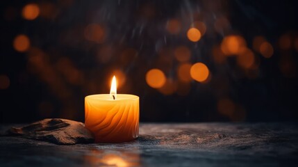 Candle Burning at Night in the Dark with focus in foreground - obrazy, fototapety, plakaty