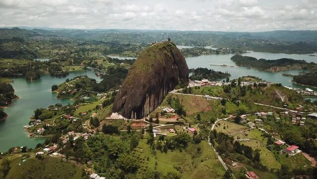 Aerial drone footage of El Penon de Guatape near Medellin in Antioquia, Colombia. Large and unique alone rock with stairs to the top, touristic place. Big stone in Colombia. High quality 4k footage.