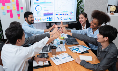 Diverse business team celebrate successful meeting with high-fives and expressions of happiness in corporate office meeting represent unity success and professional integrity. Concord