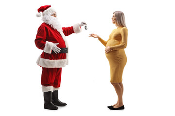 Full length profile shot of santa claus giving car keys to a pregnant woman