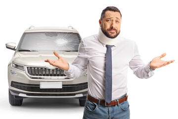Injured man with a cervical collar gesturing with hands in front of a broken windscreen