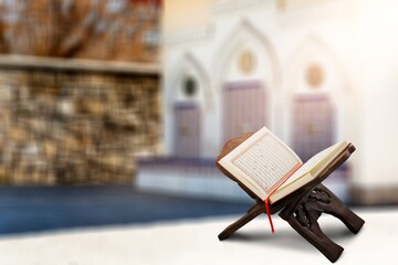 reading Quran holy book Quran on wooden seating