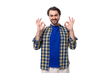 a young Caucasian brutal man with an unshaven face dressed in a blue plaid shirt shows that everything is ok