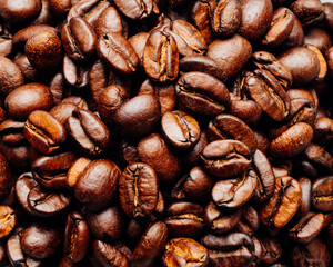 very close image of a surface of dark roast coffee beans seen from above