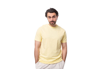 caucasian brutal charming guy with a beard dressed in a summer t-shirt on a white background with copy space