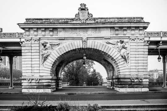 Central arch of historical Bir Hakeim Bridge in Paris, France. Black and white image.