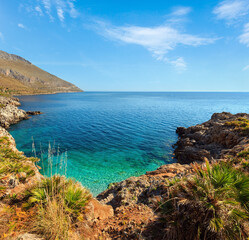 Fototapeta na wymiar Paradise sea bay with azure water and beach view from coastline trail of Zingaro Nature Reserve Park, between San Vito lo Capo and Scopello, Trapani province, Sicily, Italy. Two shots stitch image.