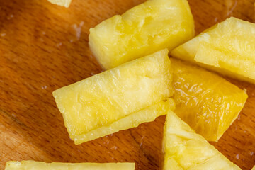 pieces of ripe pineapple sliced on a board